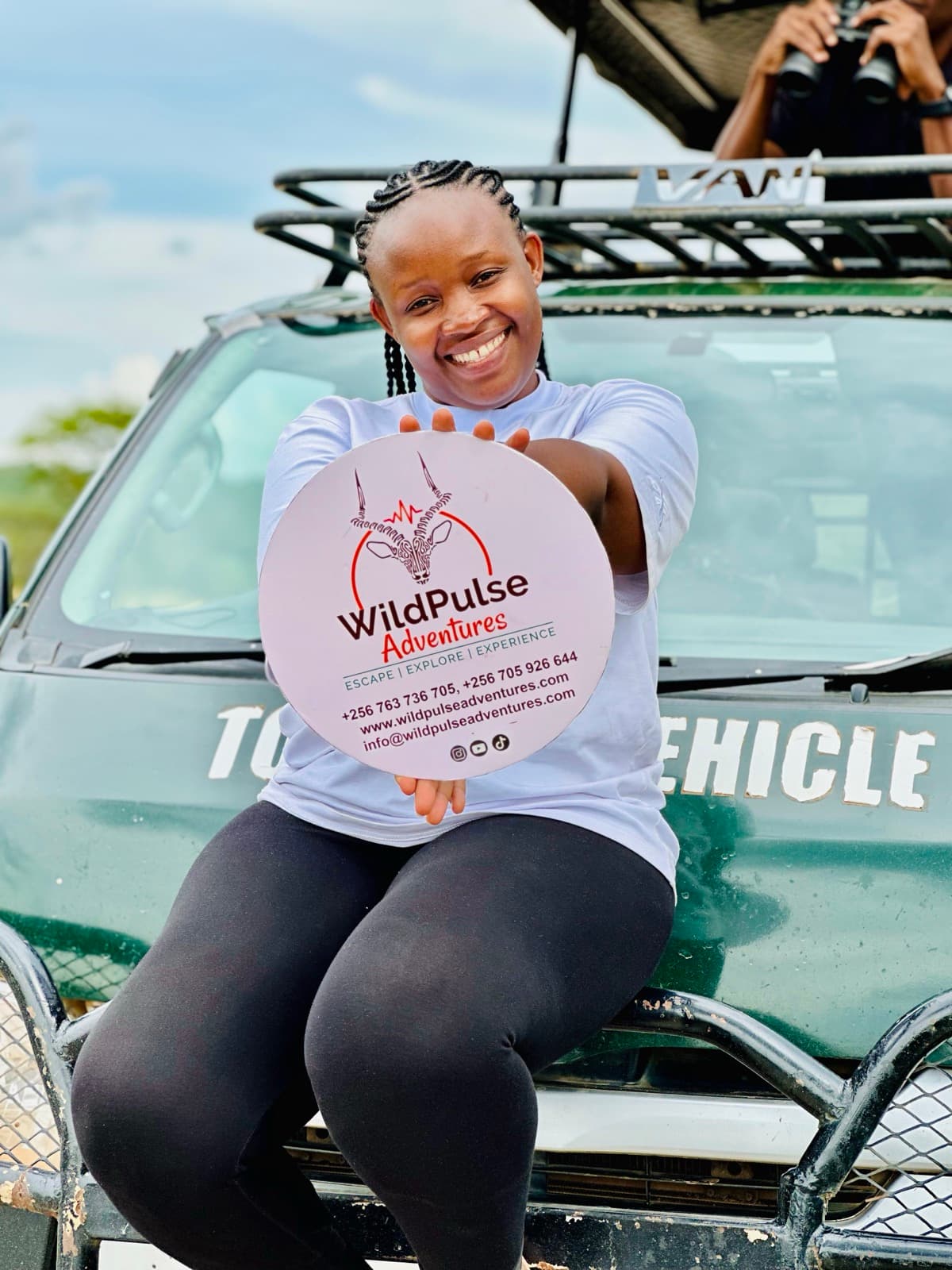 WildPulse Adventures guide with safari vehicle